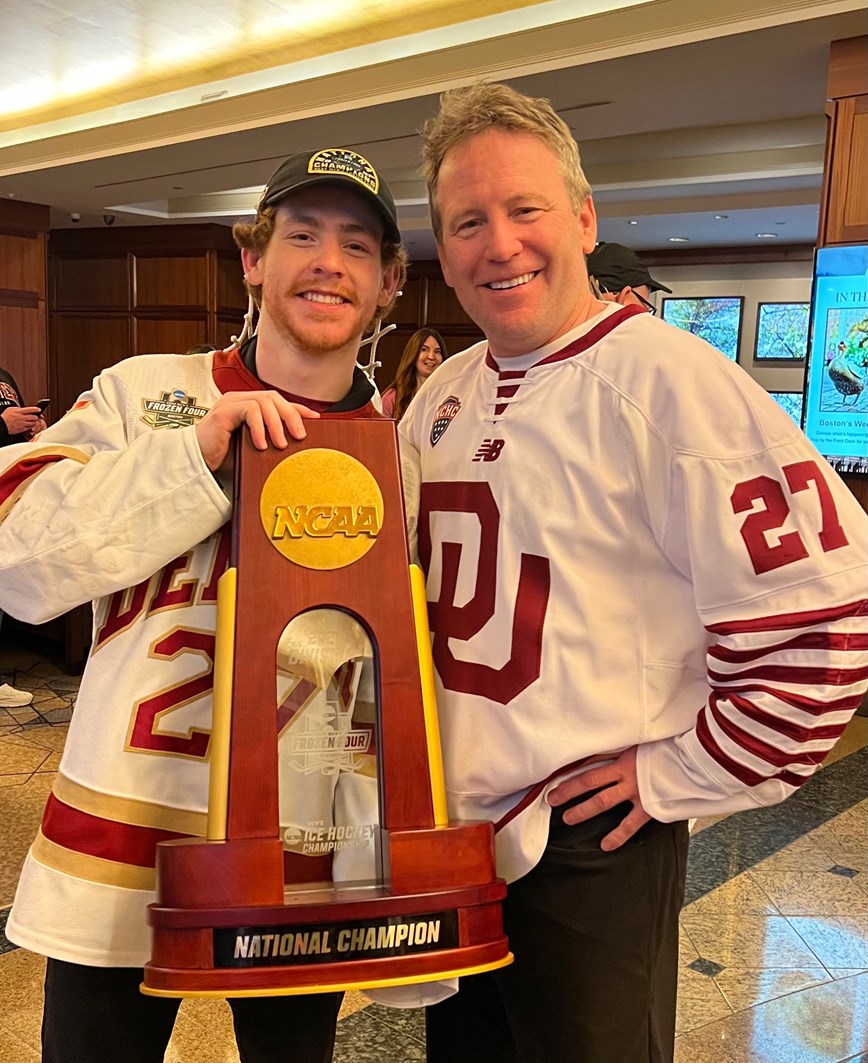 Kyle Mayhew and his father Ron with the NCAA trophy